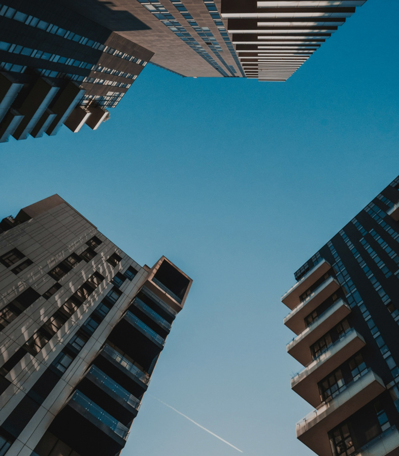 Looking up at the sky through buildings