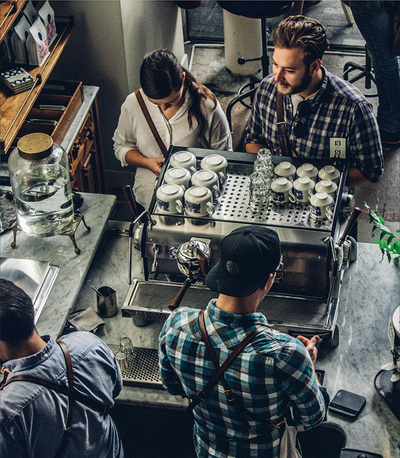 People in coffee shop being served